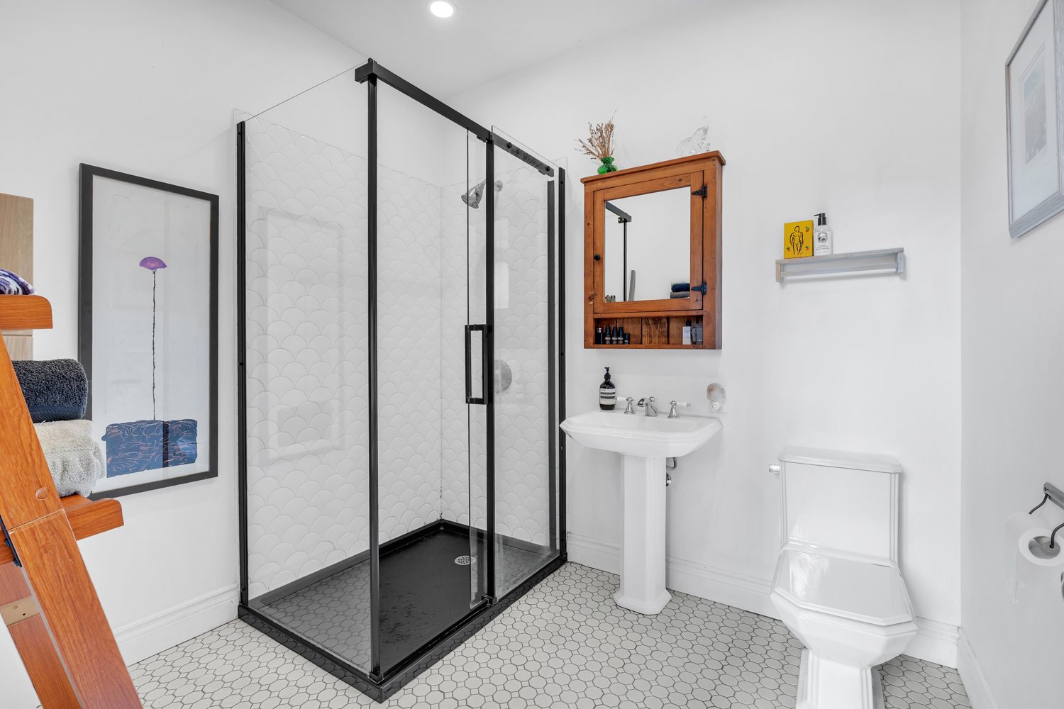 Full bathroom with black-framed glass shower
