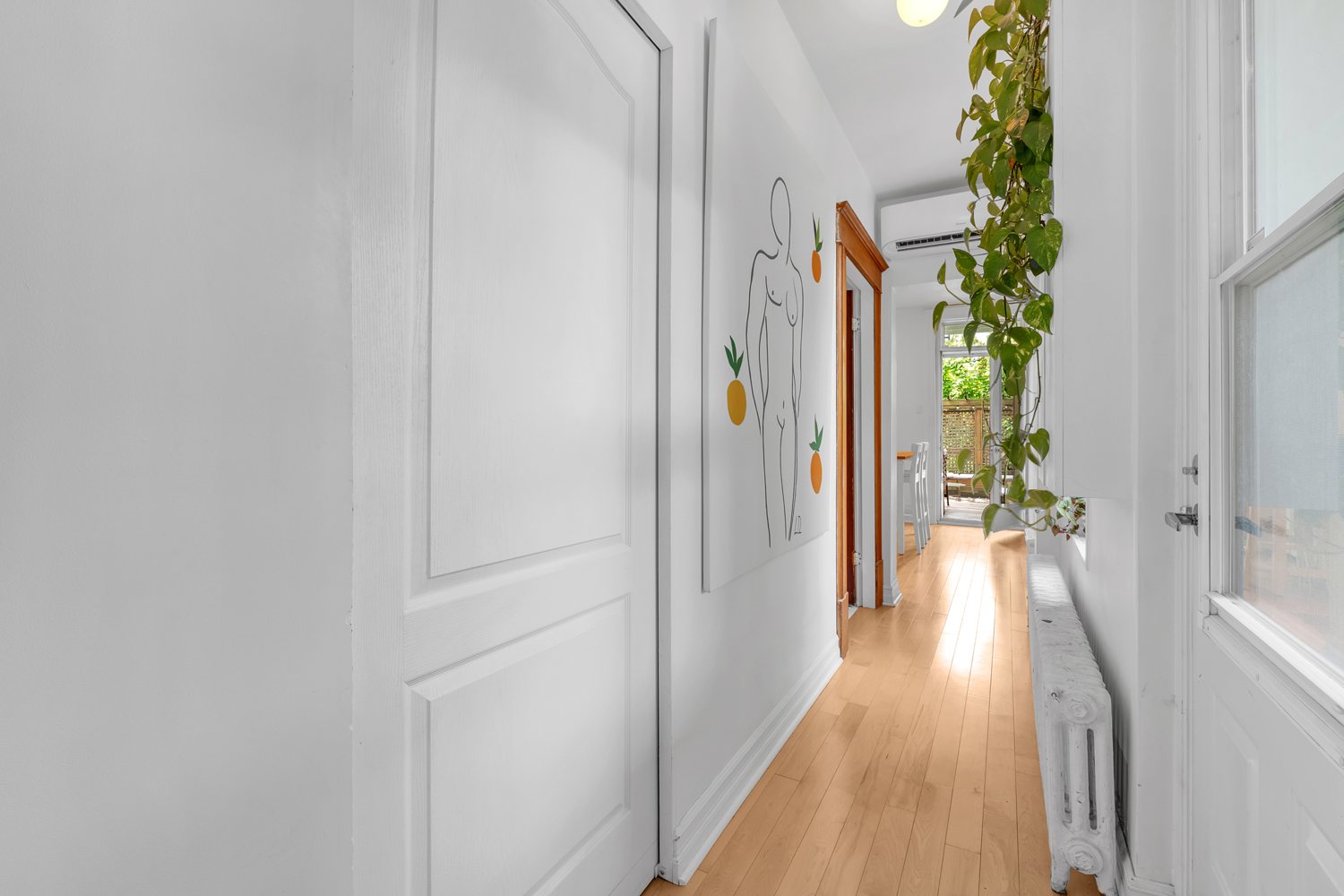 Bright hall with original radiator and wood flooring