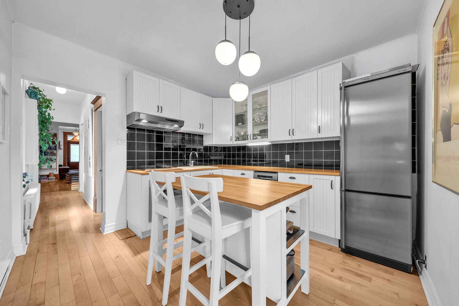 Kitchen with island, storage, and stainless appliances