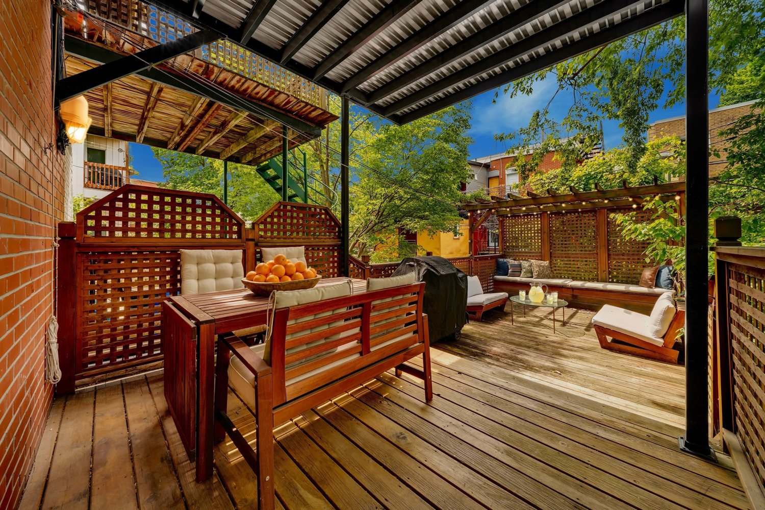 Covered private terrace surrounded by mature trees