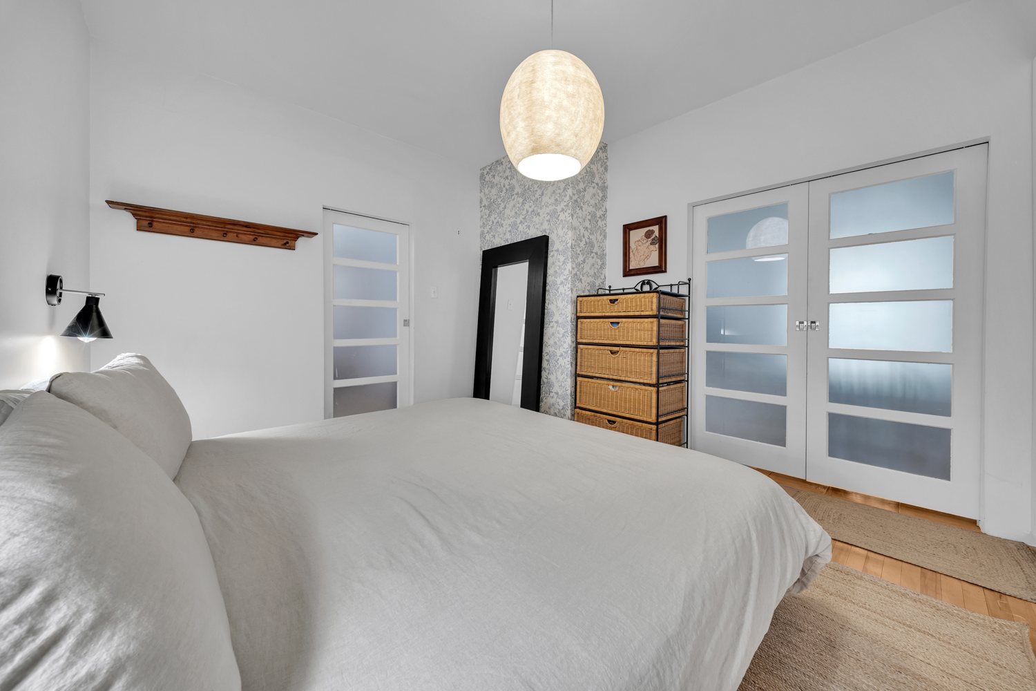 Primary bedroom with glass-panel pocket doors