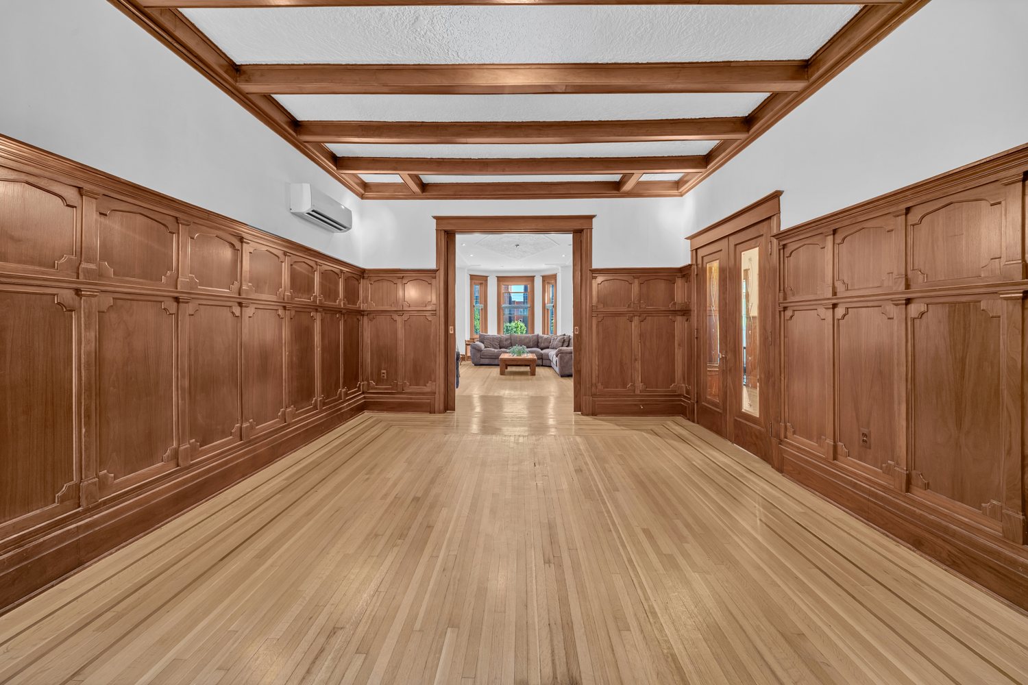 Long view through the wood-panelled rooms