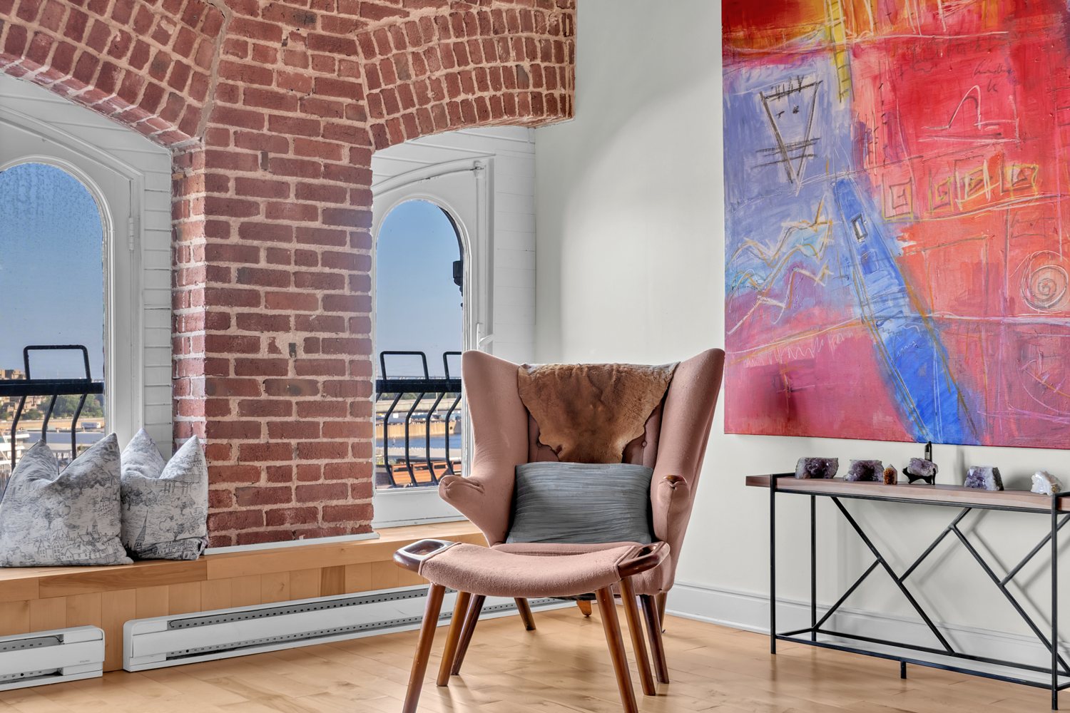 Reading area beside exposed brick and arched windows