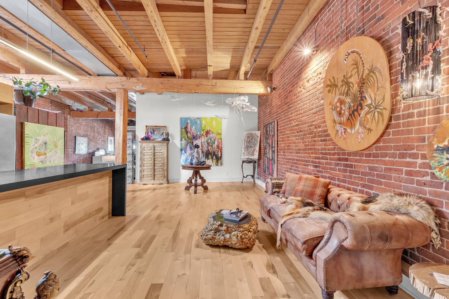 Living area with brick walls and exposed ceiling structure